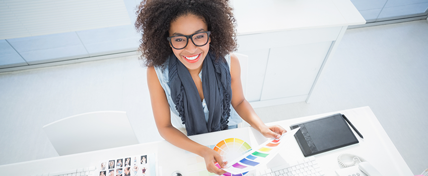 Female looking at colors and smiling with glasses on,