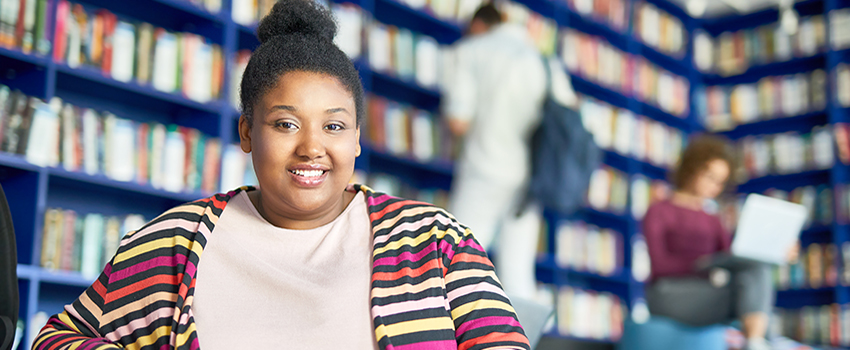 Female student studying in library.