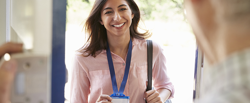 Women showing badge as she walks in an office.