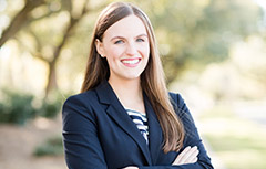 Mitchell Scholar standing outside smiling with arms crossed