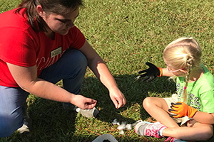 A student teacher working outside with a child.