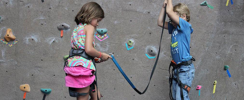 Two kids on rock wall