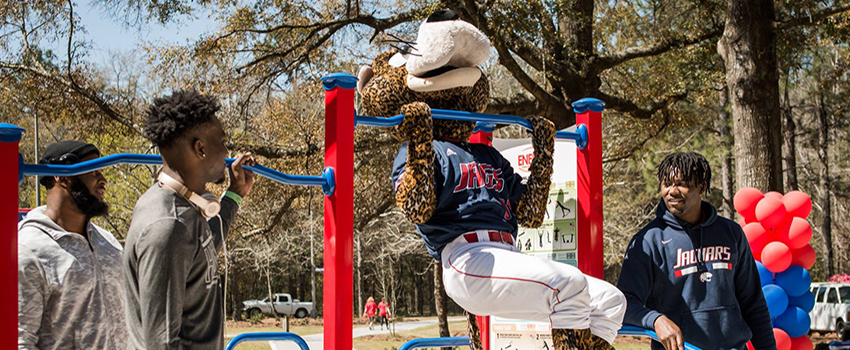 Southpaw with students doing pull ups on the Jag Fitness Trail.