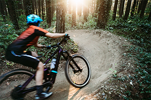 Person biking in the woods.