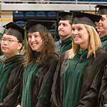 Graduate smiling in cap and gowns